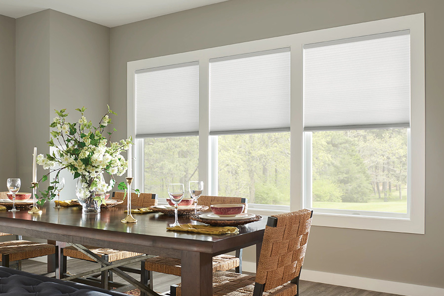 White cellular shades on dining room windows