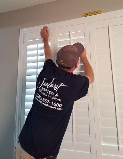 Shutter installation in Boston bedroom.