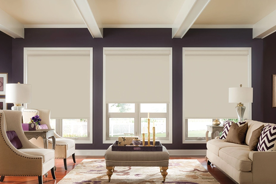 Big windows let in lots of heat. Use convenient motorized shades to easily cover them and cool off. White motorized shades on large living room windows