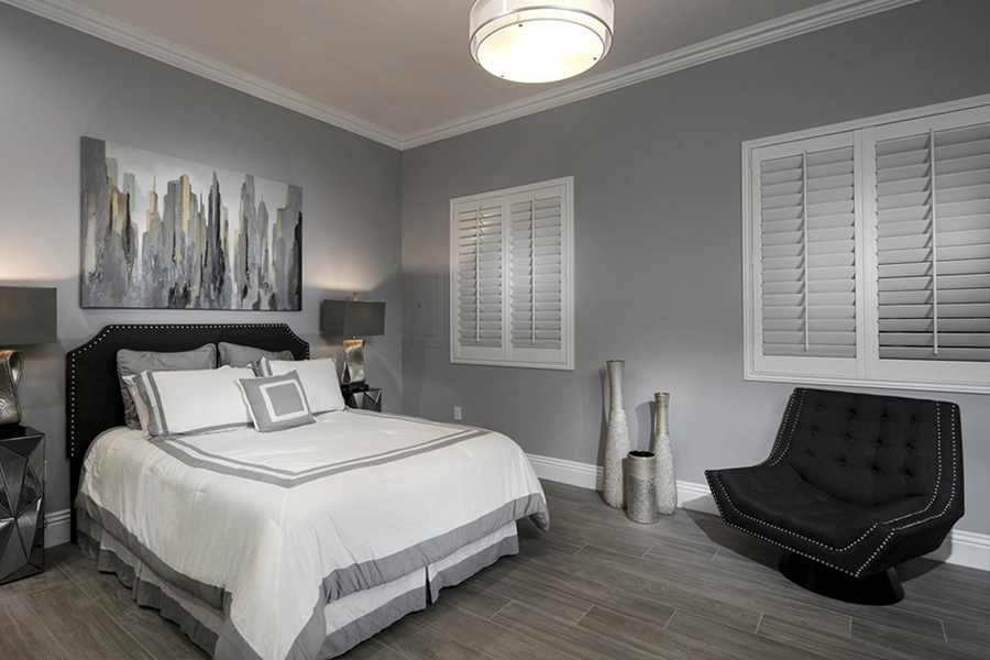 Close your custom Polywood shutters to beat the heat and keep your Boston bedroom cool. White Polywood shutters on bedroom windows